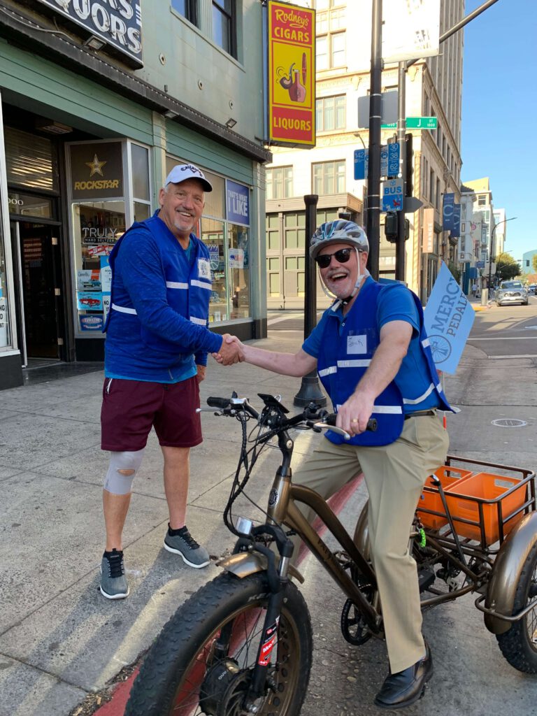 Two men shaking hands and smiling